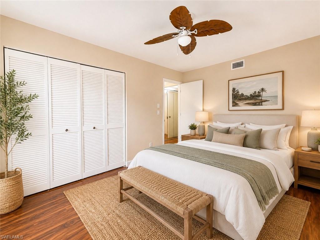 Warm-toned wood-finish flooring complements the neutral wall color