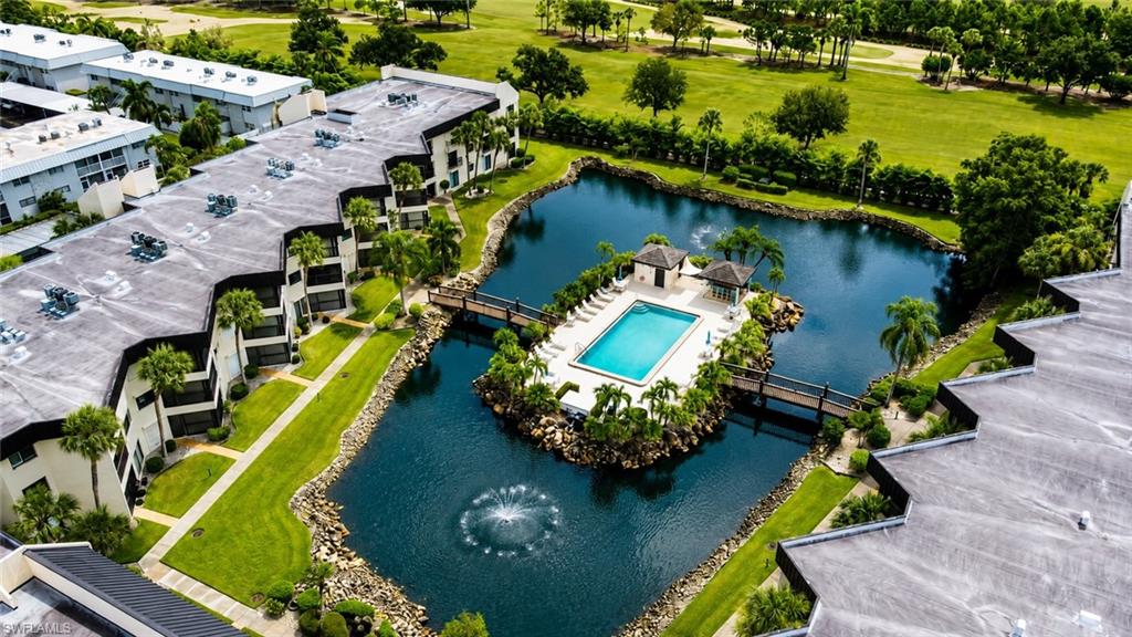 Lush green landscaping surrounding a central pond with a fountain