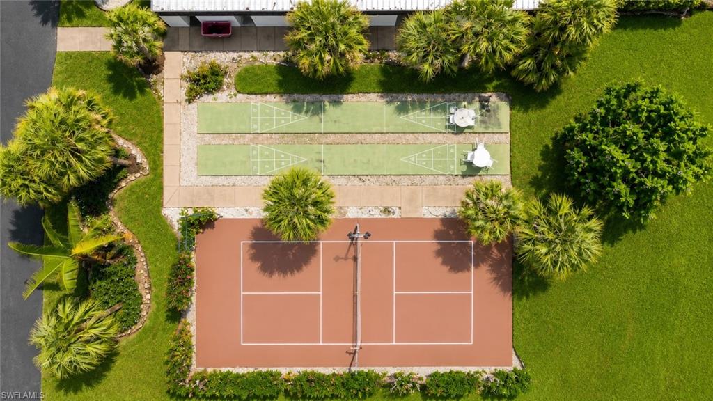 Aerial view showcasing a tennis court and two shuffleboard courts