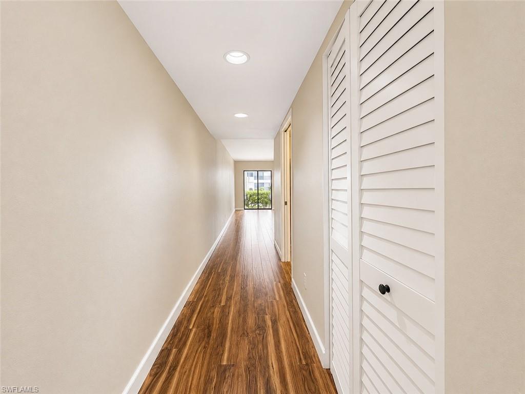 Hallway featuring wood-finish flooring and recessed lighting