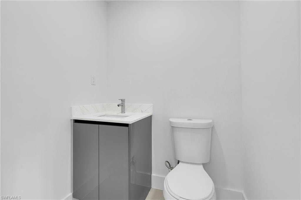 half Bathroom featuring toilet and vanity