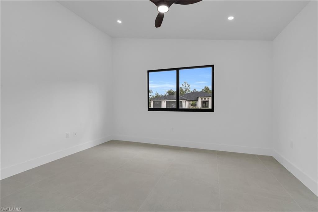 Empty room featuring recessed lighting and a ceiling fan