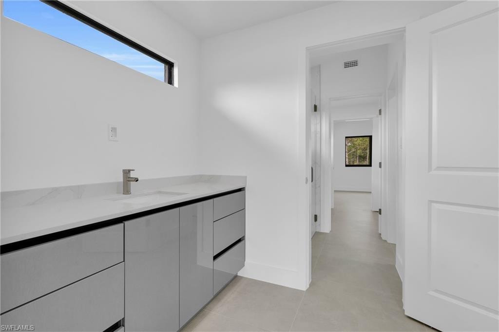 Bathroom with vanity and baseboards
