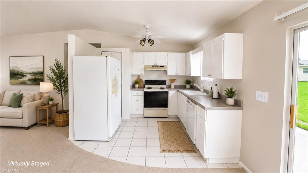 Kitchen featuring white cabinetry, a white refrigerator, a black and stainless steel range, and a dishwasher