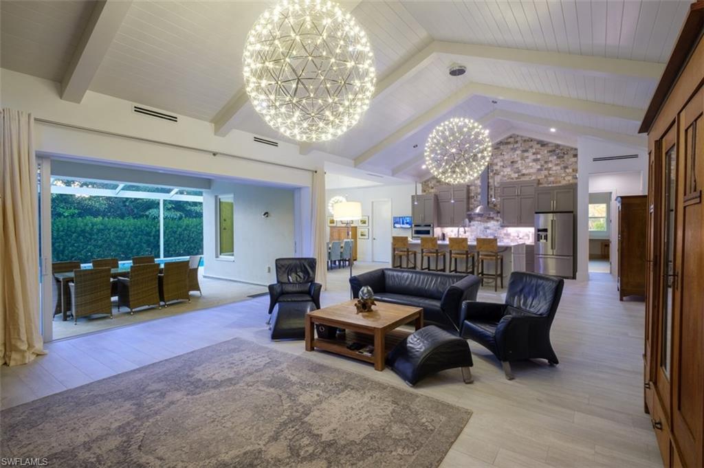 Living Area with impressive chandeliers, and wood ceiling