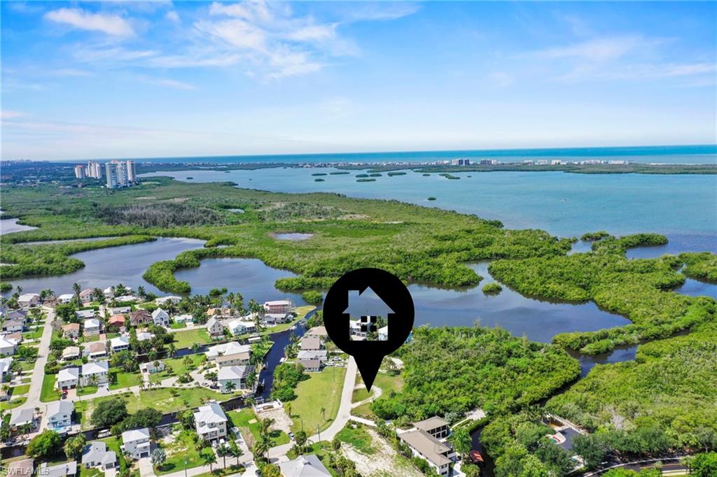 Aerial perspective showcasing waterfront properties, extensive green spaces, and distant coastal waters