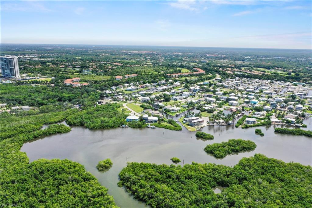 Aerial perspective of a waterfront community featuring numerous properties with water access