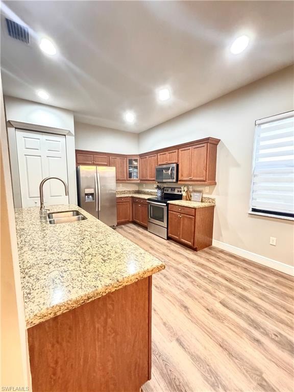Kitchen featuring wood-finish flooring, recessed lighting, and a dual basin stainless steel sink with a high-arc faucet