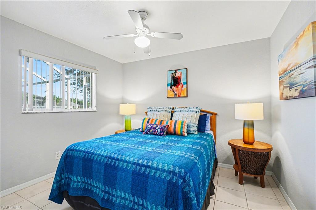 Bedroom featuring a window with vertical blinds, a ceiling fan, and tile flooring
