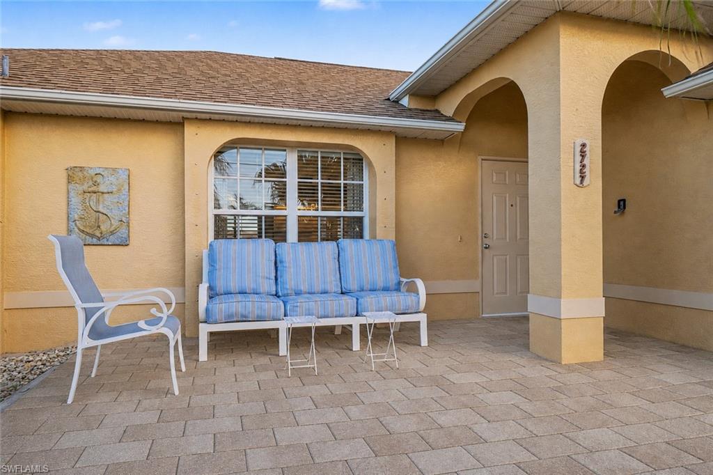 Arched entry with a light-colored door and decorative address numbers