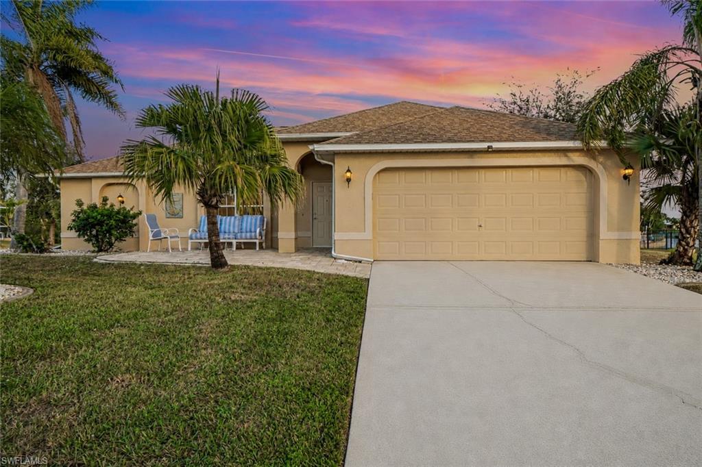 Evening sky - Single-story residence featuring a two-car garage, concrete driveway, and a front patio