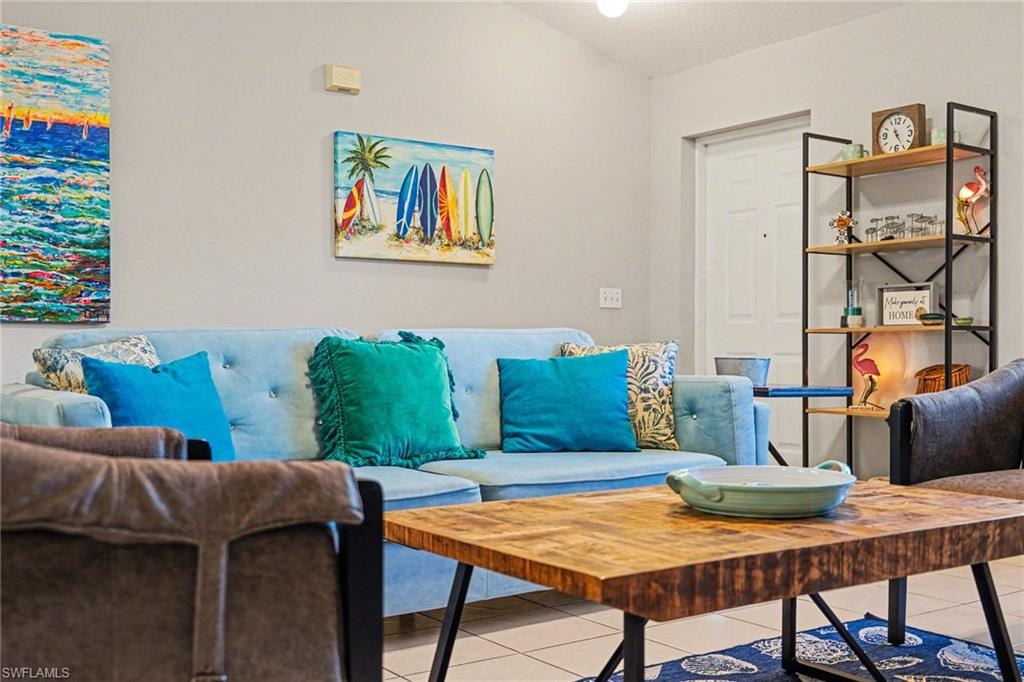 Living area featuring light gray walls and tile flooring