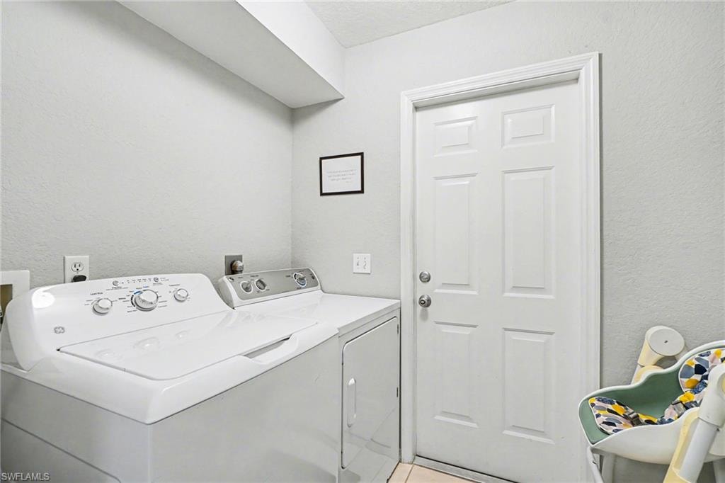 Laundry area with neutral wall tones and a paneled door