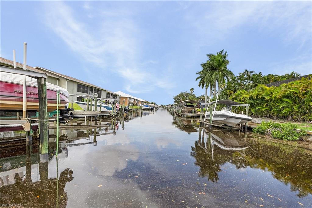Waterfront property with direct canal access featuring a private boat lift and dock