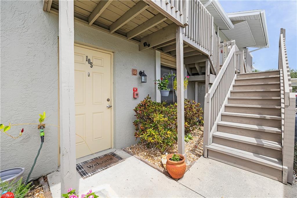 Ground-floor entry with a panel door, featuring a dedicated outdoor light fixture