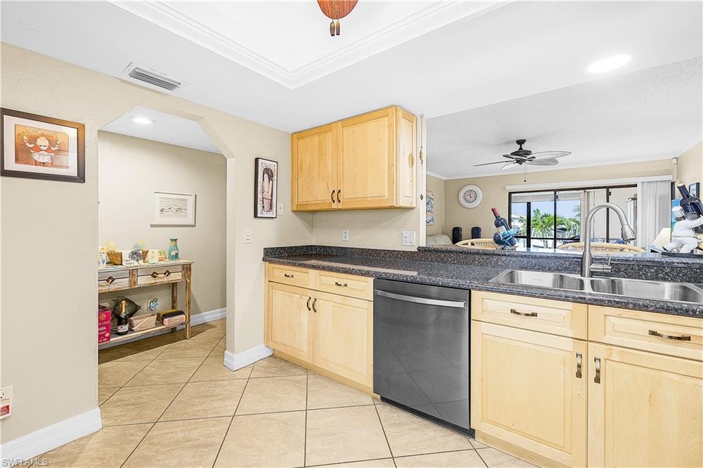 Kitchen featuring wood-finish cabinetry, dark speckled countertops, and tile flooring