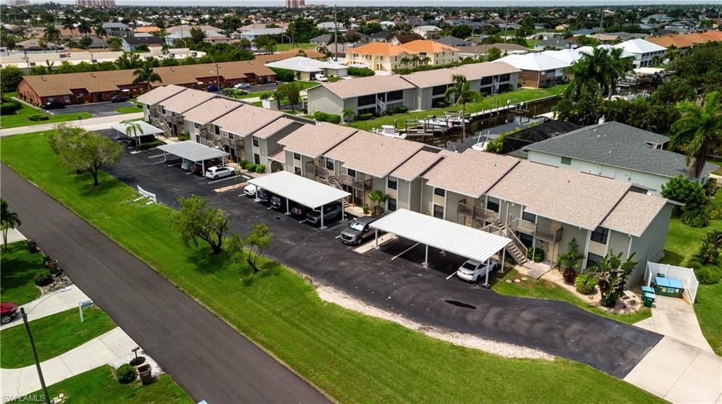 Multi-unit residential buildings featuring neutral-toned siding and light-colored shingle roofs