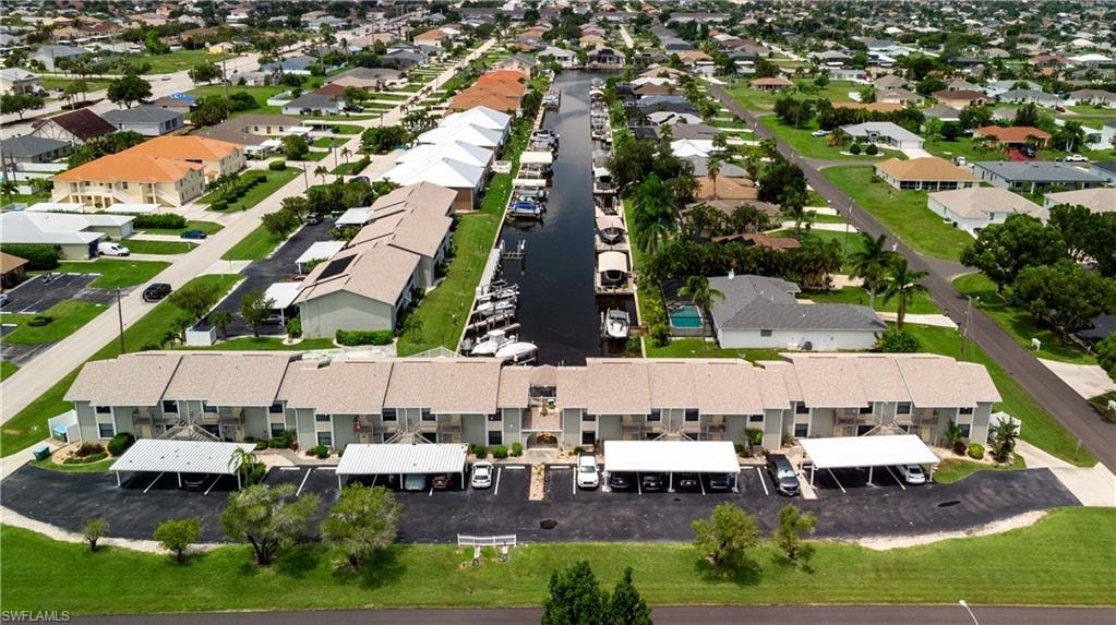 Canal-front condominium community featuring multiple buildings with individual carports and boat docks