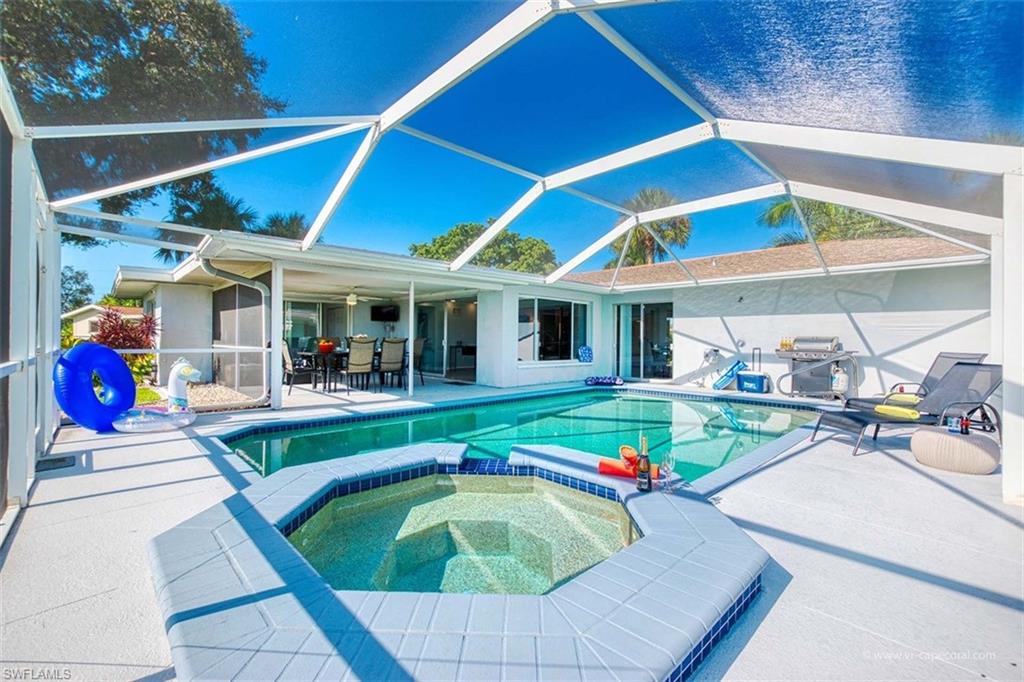 Screened lanai featuring a swimming pool and integrated spa