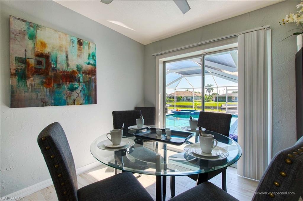 Sliding glass doors open to a screened pool area with water views
