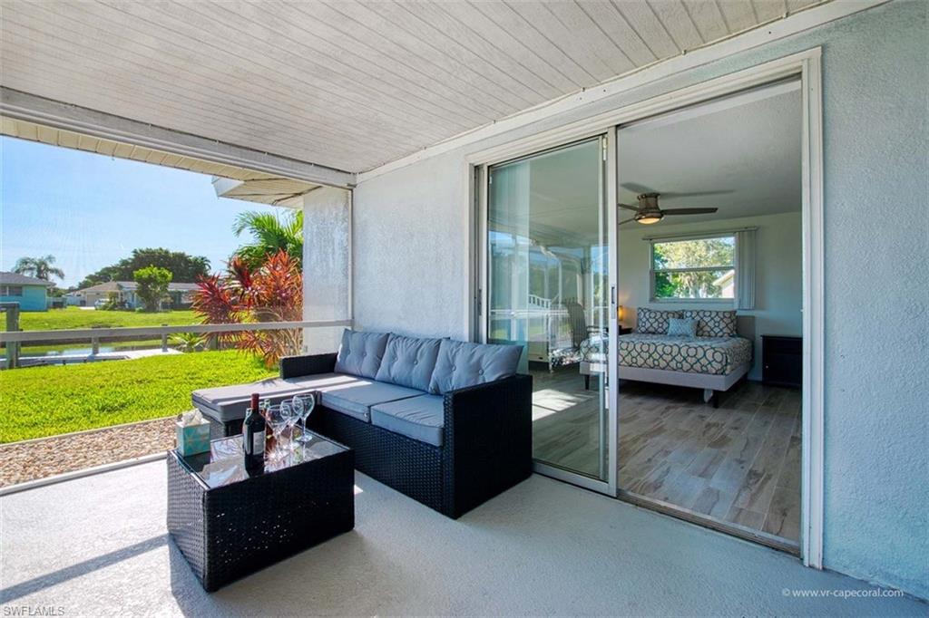 Covered outdoor patio featuring a textured concrete floor and an open screen enclosure