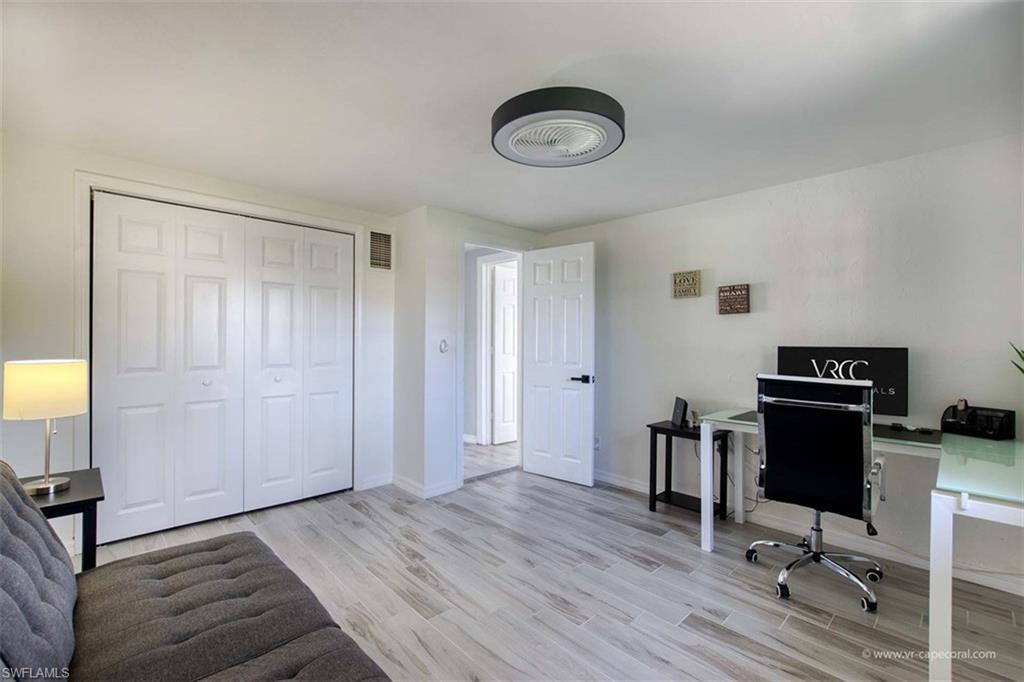 Bright room featuring light-toned wood-finish flooring