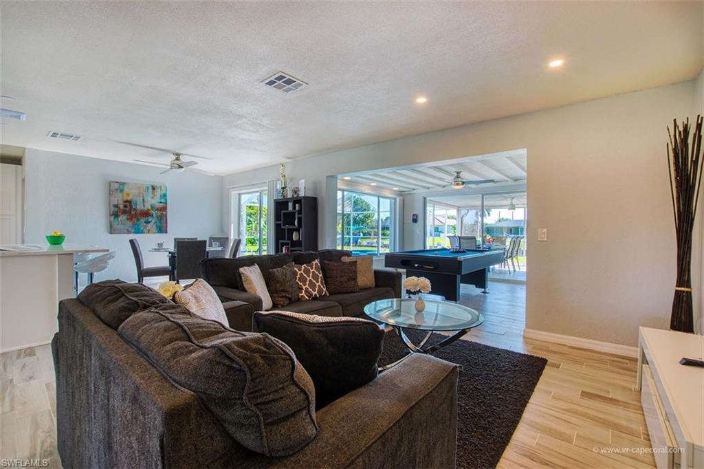 Spacious open-concept interior featuring light-toned walls and wood-finish flooring