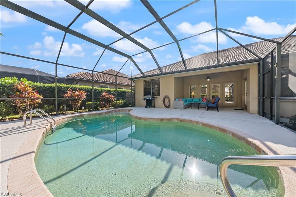 Outdoor pool featuring a lanai, a sunroom, ceiling fan, a patio area, and a grill