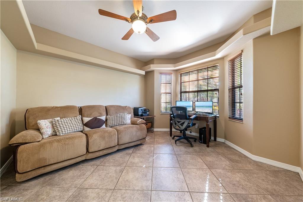 Office space featuring light tile patterned floors and a ceiling fan