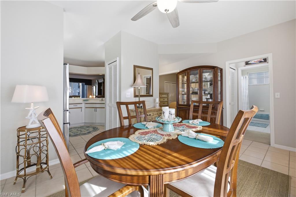 Dining area featuring tile flooring, a ceiling fan, and access to the kitchen