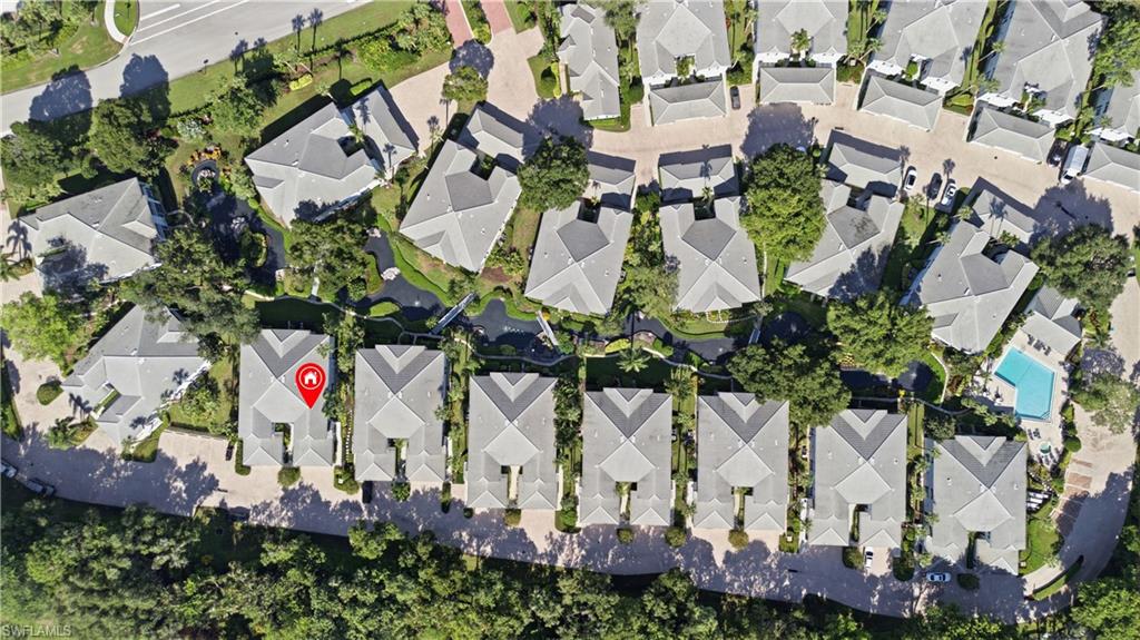 Aerial perspective showcasing a residential community with uniform gray-tiled roofs