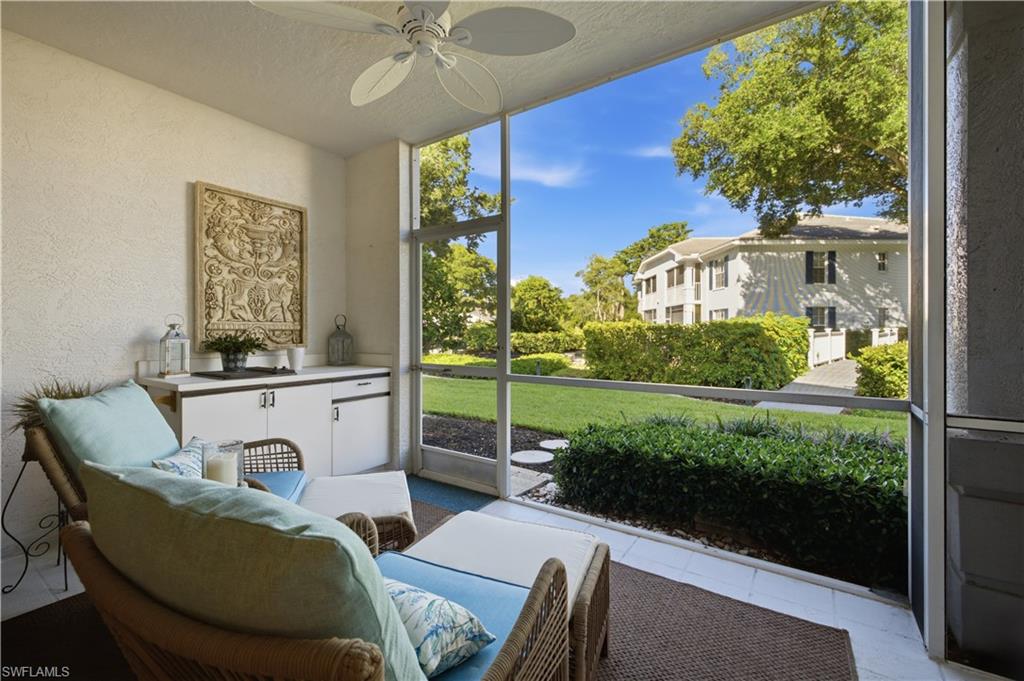 Screened patio with a ceiling fan, built-in cabinetry, and textured walls