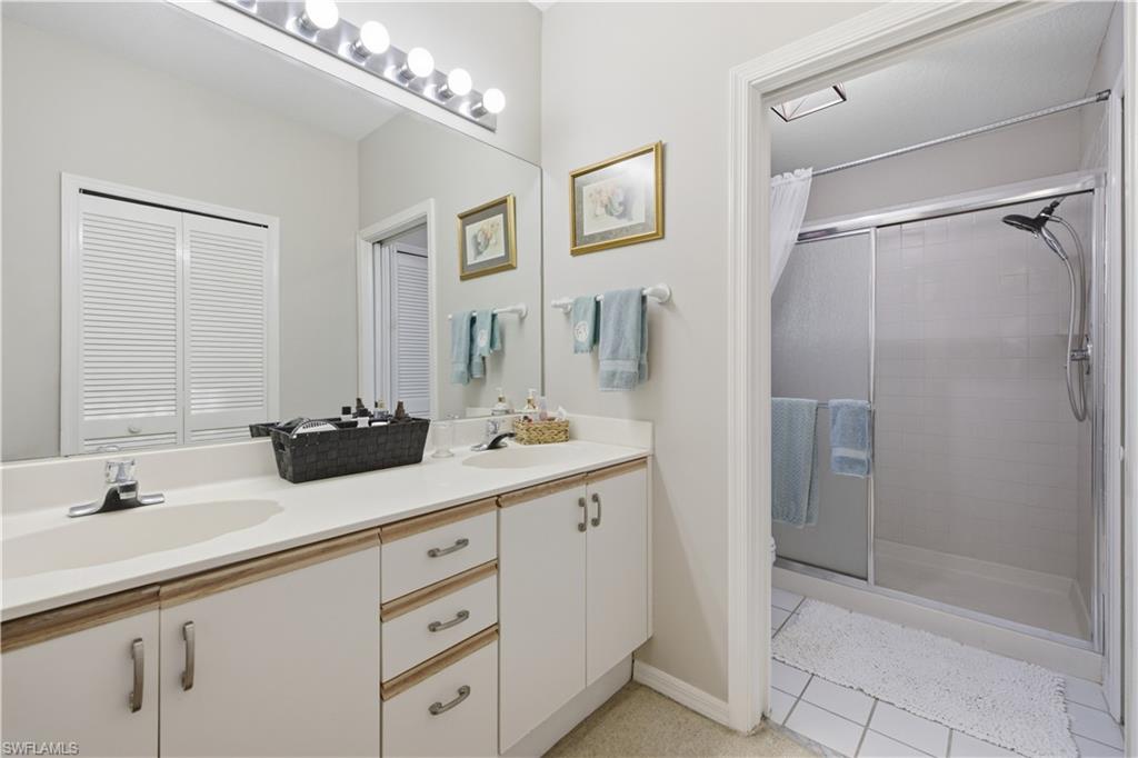 Dual vanity with integrated sinks and white cabinetry