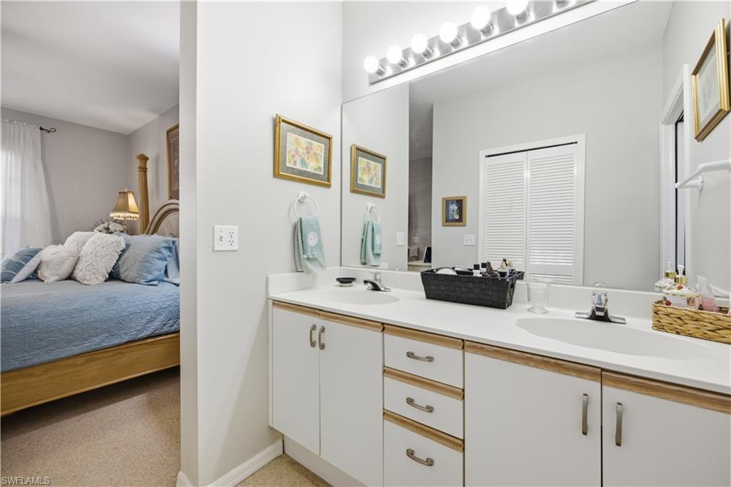 Double vanity with white cabinetry and integrated sinks