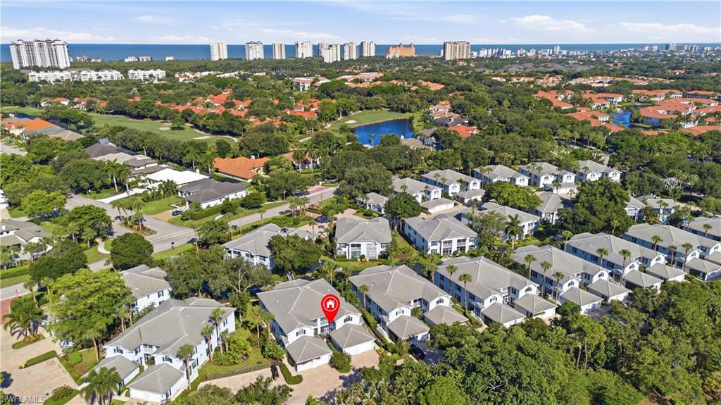 Aerial perspective showcasing the property within a residential community featuring mature landscaping
