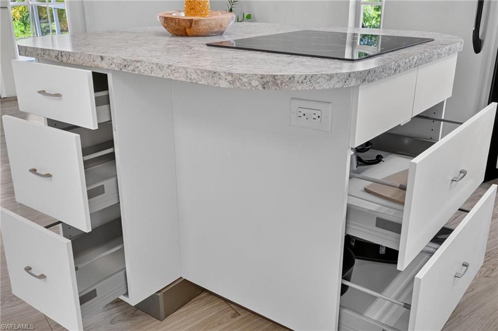 KITCHEN ISLAND HAS EXTENISVE STORAGE