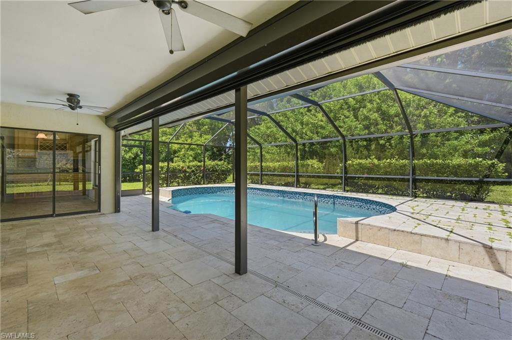 Covered patio featuring an in-ground swimming pool with a screened enclosure
