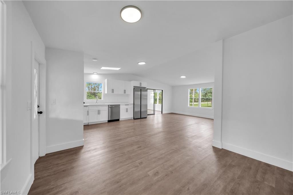 Open concept living area with wood-finish flooring