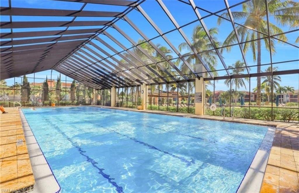 Enclosed lap pool with clear glass roof and wall panels