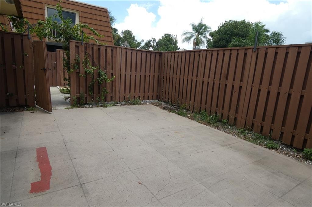 Private patio area featuring concrete paving and a privacy fence