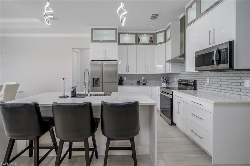Contemporary kitchen featuring an oversized island with a built-in sink and seating