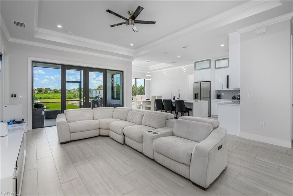 Open-concept living space with light wood-finish flooring