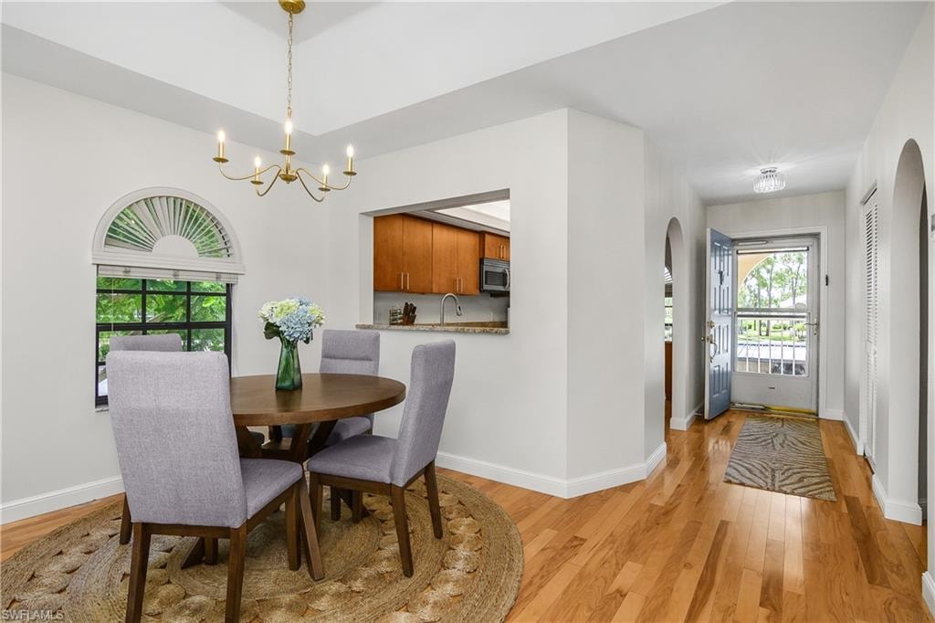 Modern updated dining room with window views of lush trees
