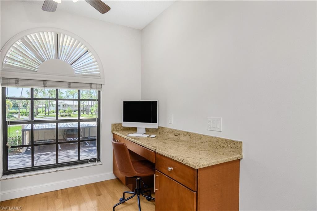 Home office featuring light wood-type flooring and ceiling fan