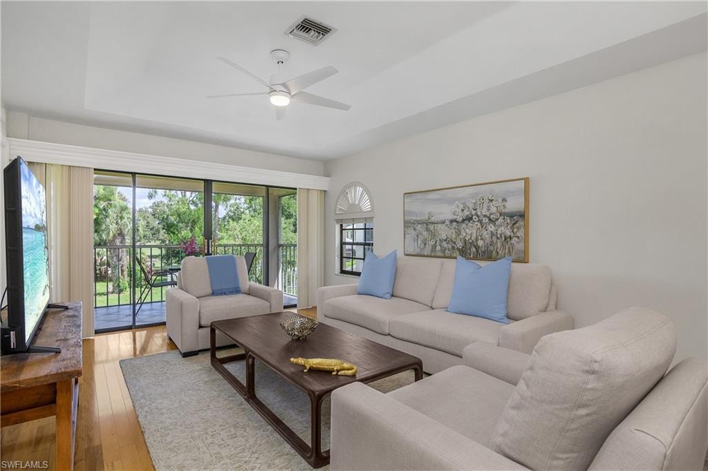 Living area with light wood-style flooring and a ceiling fan