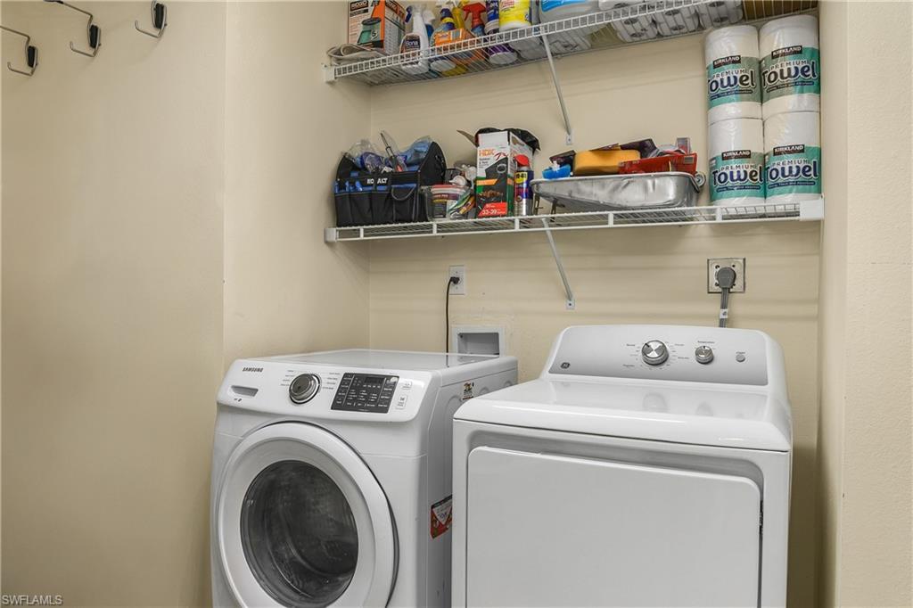 Laundry Room featuring washing machine and clothes dryer and extra storage