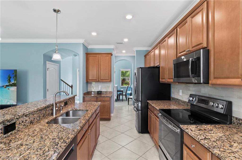 Large kitchen with ample surface space, stainless steel appliances, and a butlers pantry.