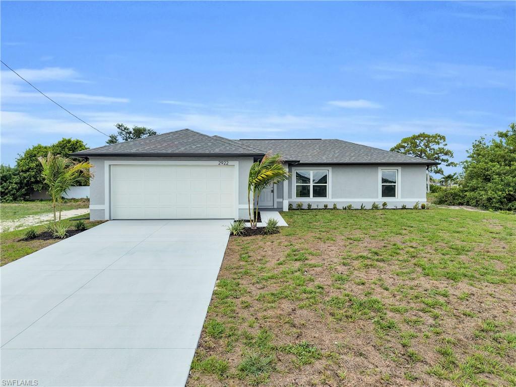 Contemporary single-story residence with a gray stucco exterior and dark shingle roof