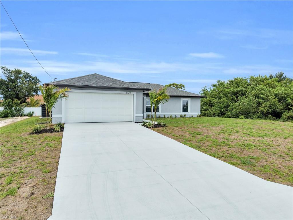 Contemporary single-story residence featuring a gray exterior, white trim, and a dark shingle roof