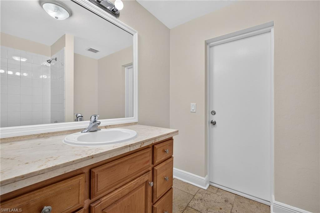 Minor bathroom with exterior door to fenced area of backyard